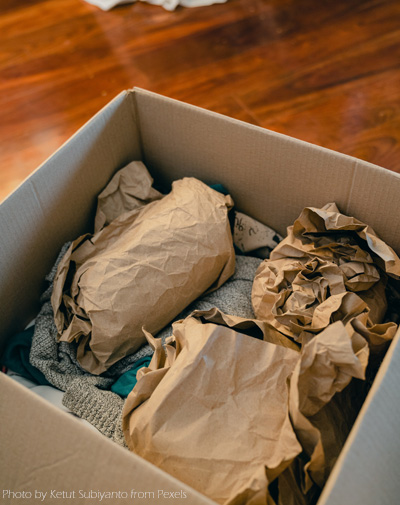 A box of brown paper bags on top of the table.